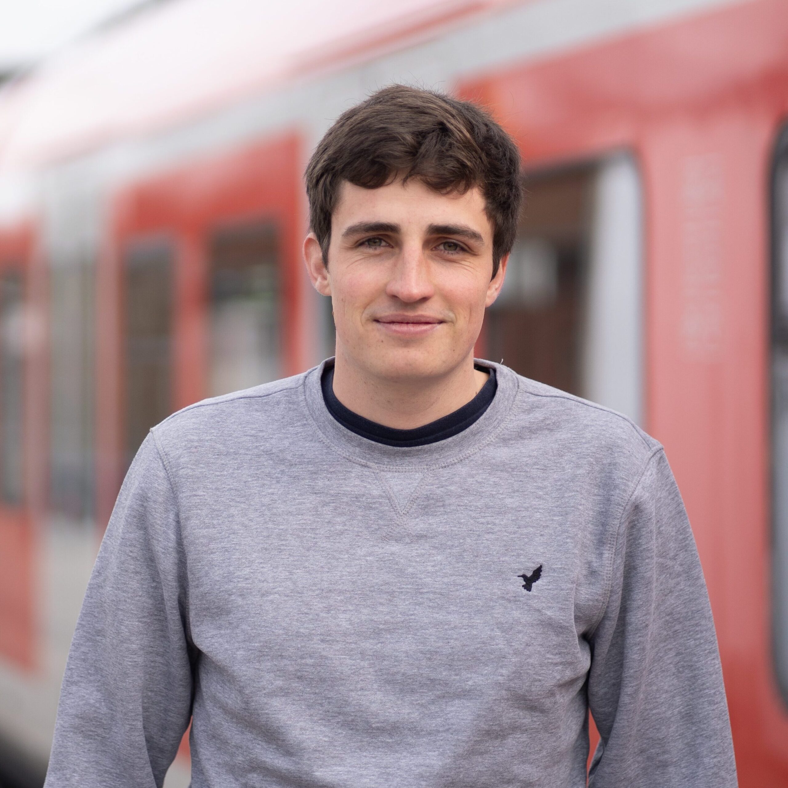 Jakob Koch der vor einer S-Bahn steht.